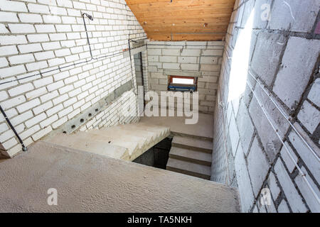 empty interior in house without repair with white silicate brick walls Stock Photo