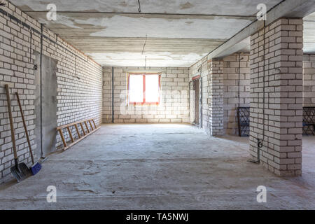 empty interior in house without repair with white silicate brick walls Stock Photo