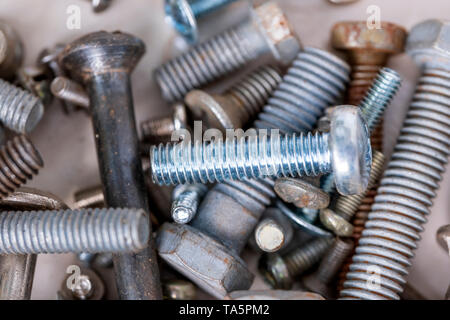 Metal bolts of different diameters, new and old, used in close-up Stock Photo