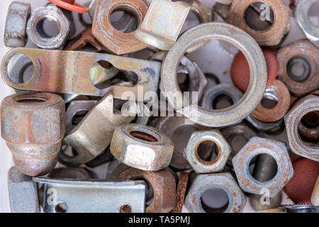 Metal nuts of different diameters, new and old, used in close-up Stock Photo