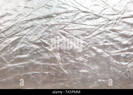 Abstract texture. Crumpled silver metallic shiny fabric background. Copy space for text. Horizontal and vertical. Celebration, holidays concept Stock Photo