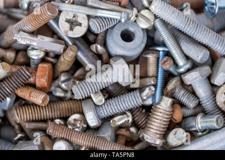 Metal bolts of different diameters, new and old, used in close-up Stock Photo