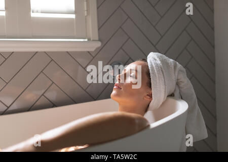 Beautiful woman relaxing in the bathtub