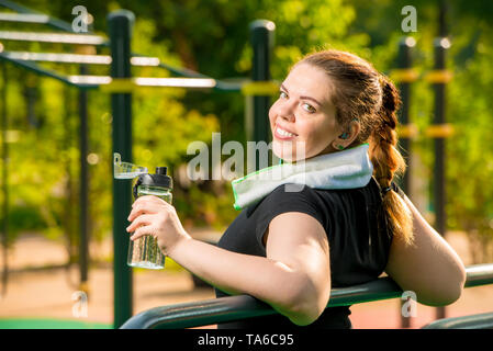 girl over size after workout resting, work on your body concept photo Stock Photo