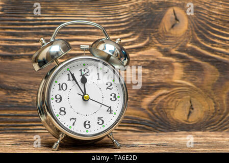 close up of retro alarm clock on wooden background, space is right Stock Photo