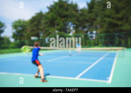 Teenager boy playing tennis on court. Sport summer concept. Stock Photo