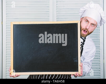 Check out cooking tips. Tips to cook like pro. Man chef hat apron hold blackboard copy space. Recipe concept. Cooking delicious meal step by step. Menu for today. List ingredients for cooking dish. Stock Photo