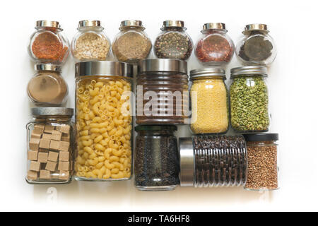 Homemade set of wholegrain cereals, pasta, spices, coffee, flour, sugar on a white tabletop. Zero waste. View from above. Healthy cooking, balanced di Stock Photo