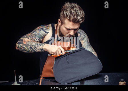 Leather Skinner produce a leatherwork in studio Stock Photo