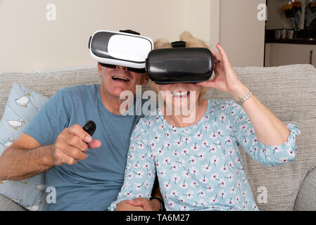 Portsmouth UK, May 2019. Elderly couple having fun wearing virtual reality goggles. Portsmouth UK, May 2019. Stock Photo