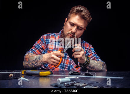 Leather master making quality products in a workshop Stock Photo