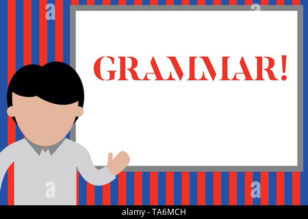 Writing note showing Grammar. Business concept for whole system structure language syntax and morphology Young man standing in front whiteboard pointi Stock Photo