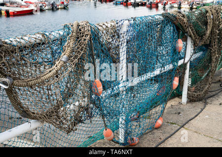 Fishing net on dock port with defocus background. Galicia Spain