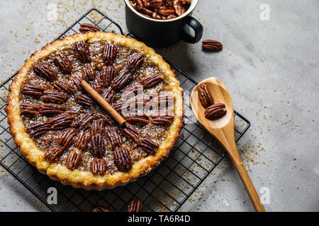 Cooling rack with tasty pecan pie on grey table Stock Photo