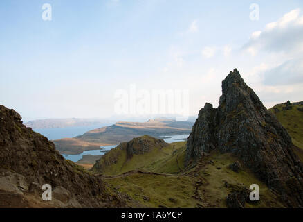 Looking out from the base of the 164ft Old Man of Storr towards Loch Leathan, with the Isle of Raasay in the far distance. Stock Photo