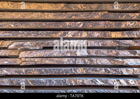 Different size sawn wooden planks stacked in pile and stored for use as building material Stock Photo