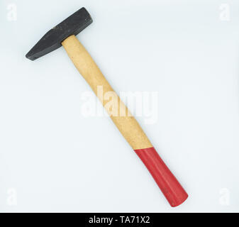 This is capture of a red and beige hammer on a white background and in a studio light Stock Photo