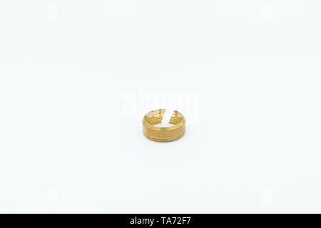 This is a capture for a yellow and silver pipe valve fitter with a white background and studio light Stock Photo