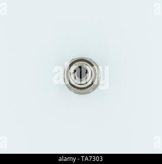 This is a capture for a yellow and silver pipe valve fitter with a white background and studio light Stock Photo