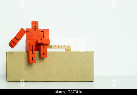 red wooden toy robot display on white background Stock Photo