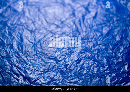 crumpled blue polyethilene film abstract background with selective focus. Stock Photo