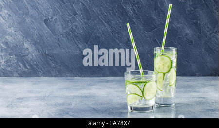 Fresh cool cucumber infused water, cocktail, detox drink, lemonade in a glass. Health care, fitness, healthy nutrition diet concept. Stock Photo