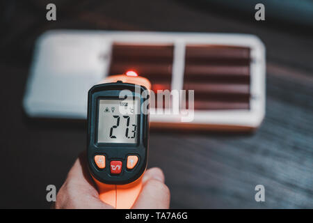 Measuring temperature of charging lithium ion battery pack showing that the temperature rising Stock Photo