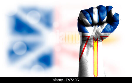 Flag of Newfoundland and Labrador painted on male fist, strength,power,concept of conflict. On a blurred background with a good place for your text. Stock Photo