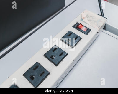 Extension power cord with bunch of socket and switch on white table Stock Photo