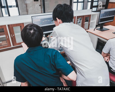 Thai Computer Engineering students working on a programming project in a computer lab Stock Photo