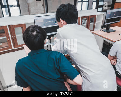 Thai Computer Engineering students working on a programming project in a computer lab Stock Photo