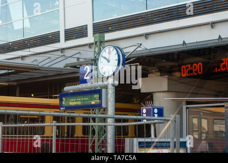 Station clock and information point at train station Berlin Ostkreuz Germany Stock Photo