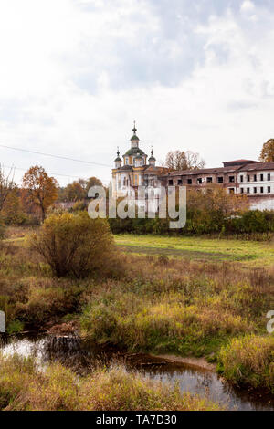 Crumbling walls and ruins of the monastery Spaso-Sumorin and dome of the Cathedral Ascension of the Lord in the town of Totma, Vologda Region, Russia Stock Photo