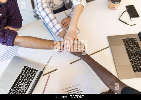 Diverse people group put hands together in stack pile at training as concept of sales team corporate unity connection, teambuilding loyalty, support i Stock Photo