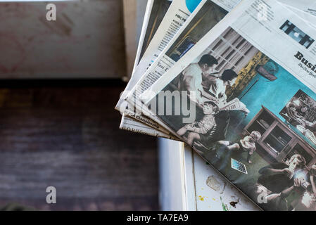 A stack of newspapers, The New York Times and USA Today, lay on a table. Stock Photo