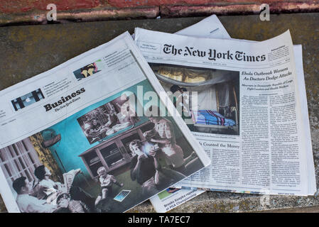 A stack of newspapers, The New York Times and USA Today, lay on a table. Stock Photo