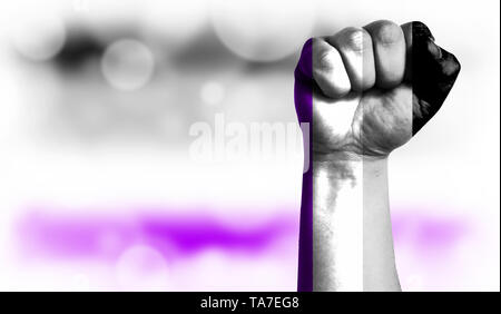 Flag of asexual painted on male fist, strength,power,concept of conflict. On a blurred background with a good place for your text. Stock Photo