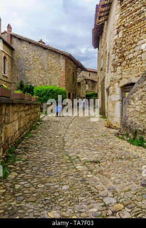 Perouges, France - May 04, 2019: Alley scene, with bride, groom and photographer, in the medieval village Perouges, Ain department, France Stock Photo