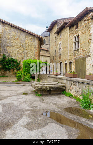 Perouges, France - May 04, 2019: Alley scene, with bride, groom and photographer, in the medieval village Perouges, Ain department, France Stock Photo