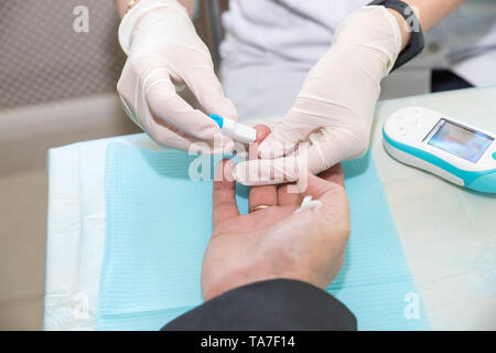 Doctor Taking Blood Sample from Boy's Finger. Diabetes Concept. Sugar in Blood. Healthcare Concept. Young Man in Uniform. White Coat. Medical Stock Photo