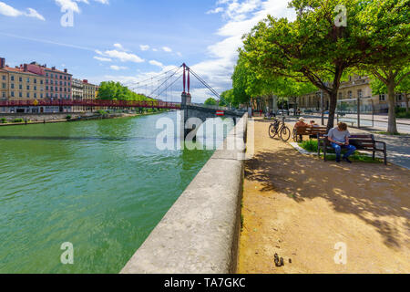 Lyon, France - May 10, 2019: The Saone River, and Saint-Gorges bridge, with locals and visitors, in Old Lyon, France Stock Photo