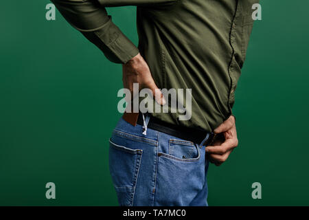 elderly man touching his back. acute symptom of osteoarthritis.c ose up cropped side view photo. Stock Photo