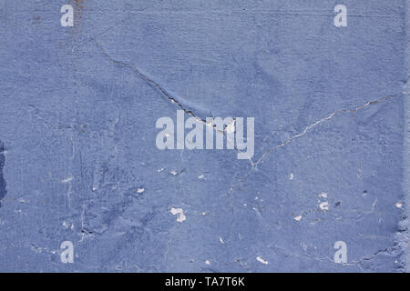 An old ragged blue plaster wall texture - Shabby wall with rundown stucco layer Texture. Close up image Stock Photo