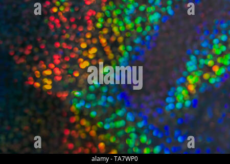 Multicolored background with many lights in blur. Glitter of sequins from the sun's rays Stock Photo