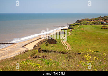 A view of a couple walking the Paston Way long distance footpath on the cliff top in North Norfolk near Overstrand, Norfolk, England, UK, Europe. Stock Photo