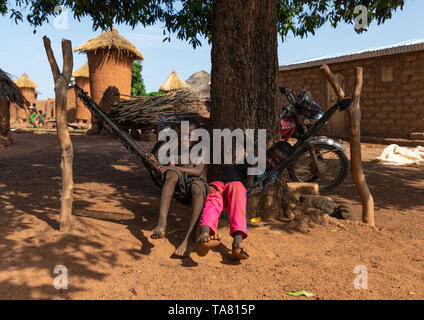 Senufo children resting on a hammock in a village, Savanes district, Niofoin, Ivory Coast Stock Photo