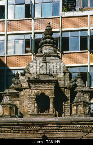 old stone stupa in contrast to a modern building. Analogue photography. kathmandu, Nepal Stock Photo