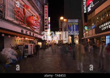 Osaka, Japan - November 2 2018: Tourist walking in a shopping street called Dotonbori Street. Giant moving crab on restaurant in Dotonbori Osaka Stock Photo