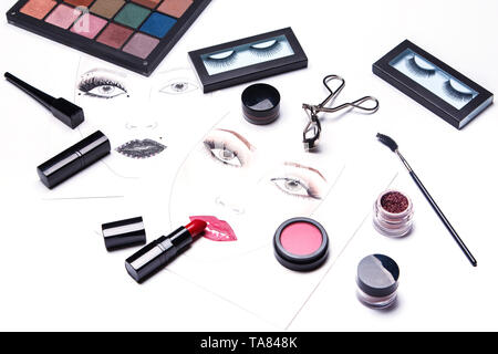 Face charts and different makeup objects and cosmetics on white background Stock Photo