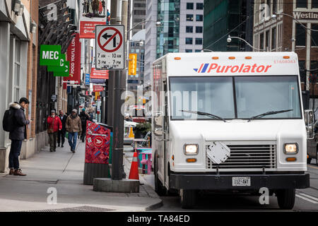 TORONTO, CANADA - NOVEMBER 14, 2018: Purolator logo on one of their delivery trucks in a street of Toronto, Ontario. Purolator is a Canadian courier s Stock Photo